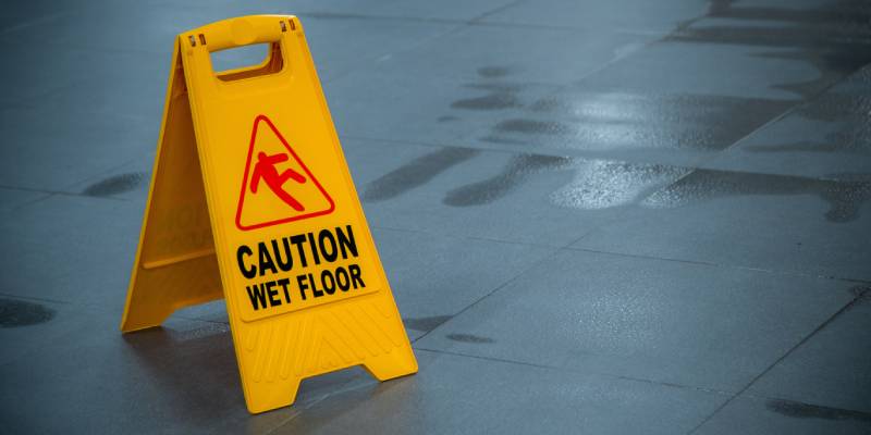 Yellow Caution Wet Floor sign on a tile floor