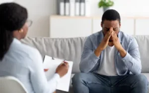 man in office talking to psychologist about emotional damages resulting from wrongful death case