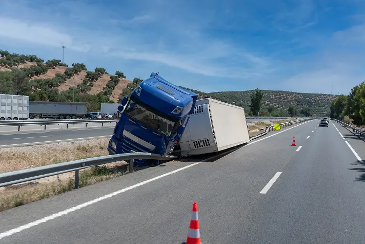 Overturned semi on highway. Contact the truck accident attorneys at OlsenDaines if you've been in an auto accident and need legal representation.