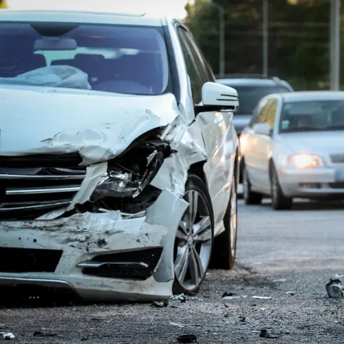 A white Mercedes with a damaged bumper after a car accident in West Highlands, WA.